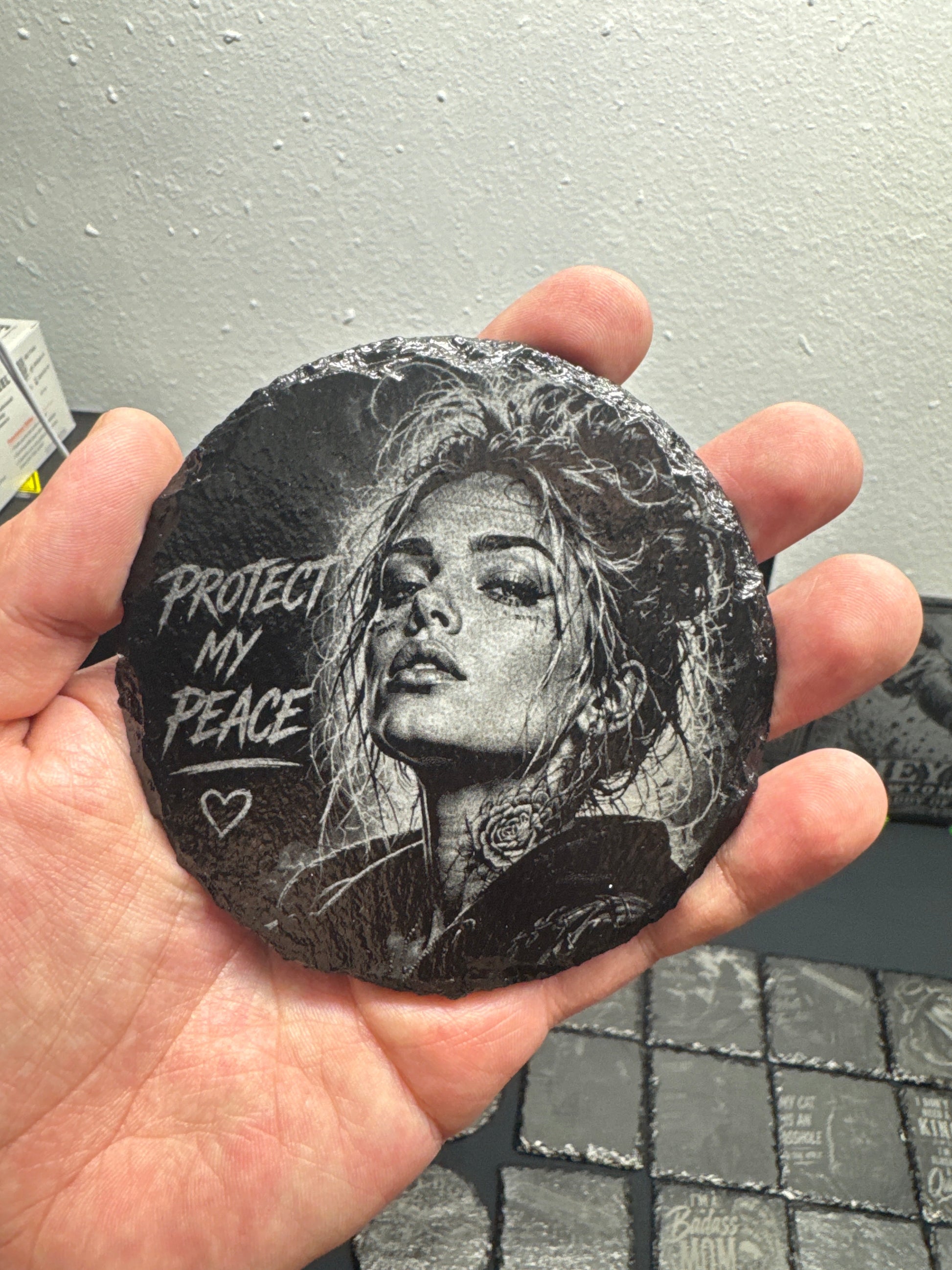 Engraved round slate coasters displayed